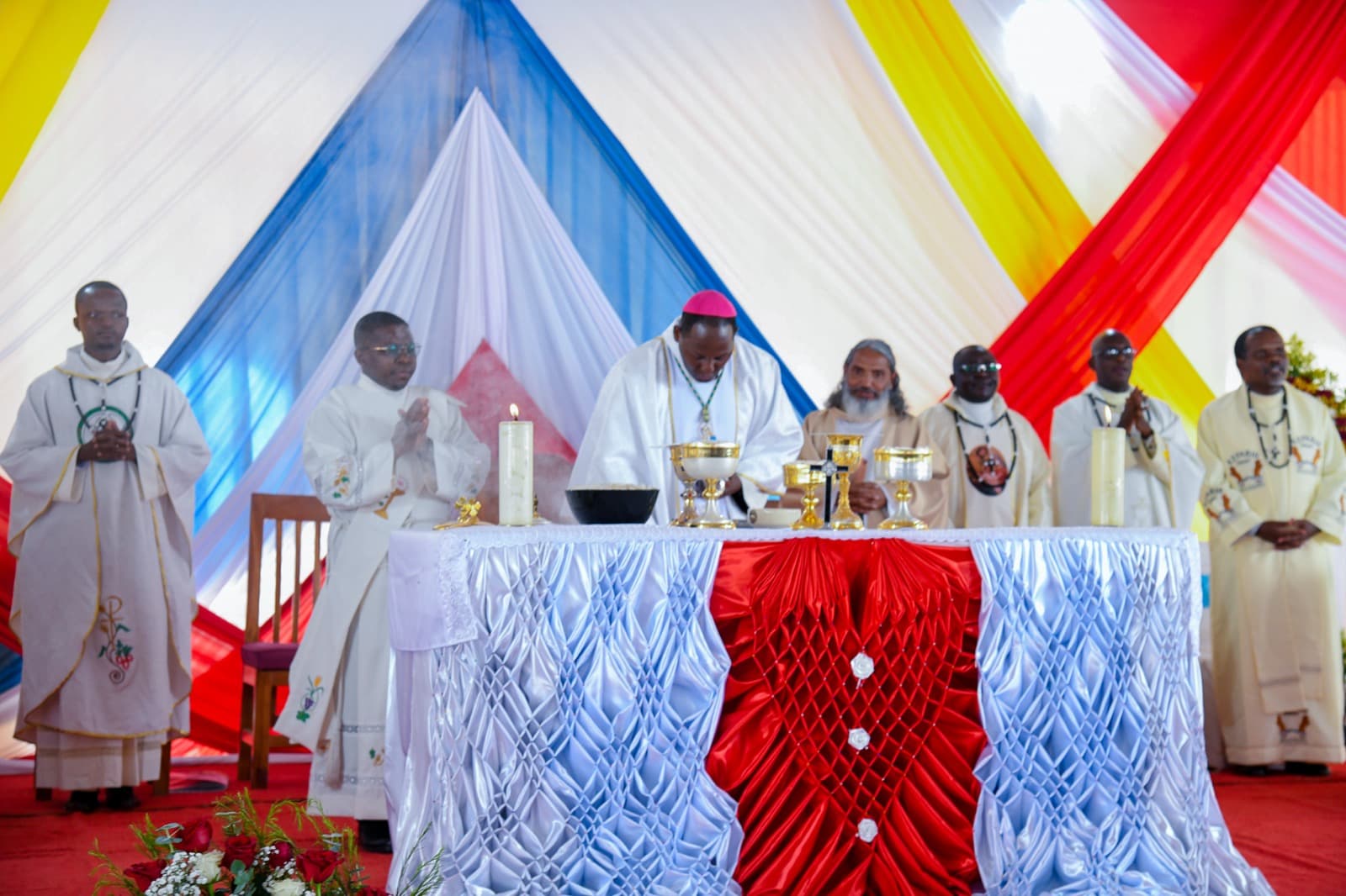 A bishop and priests concelebrate Mass at the altar during the Liturgy of the Eucharist